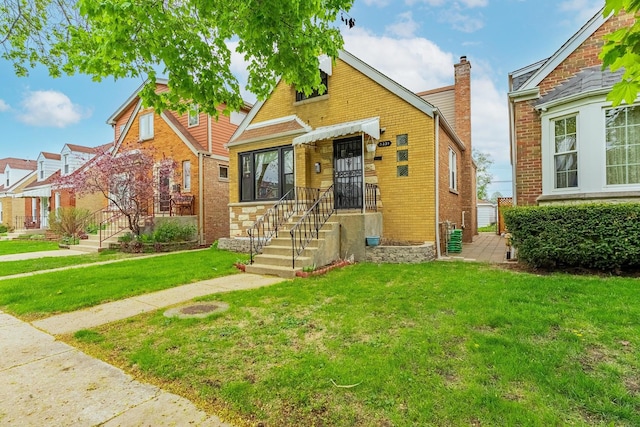 view of front of house with brick siding and a front yard