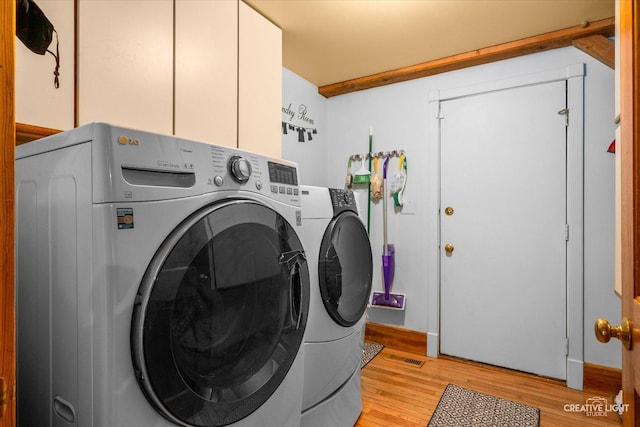 405 Cambridge Way, Bolingbrook, IL 60440 - laundry area featuring independent washer and dryer, light wood-style floors, and cabinet space