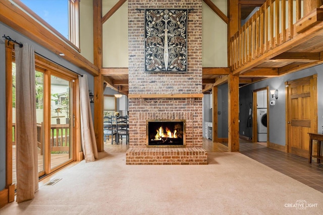 405 Cambridge Way, Bolingbrook, IL 60440 - unfurnished living room with a high ceiling, a fireplace, beamed ceiling, carpet flooring, and washer / clothes dryer