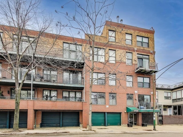view of apartment building / complex featuring a garage