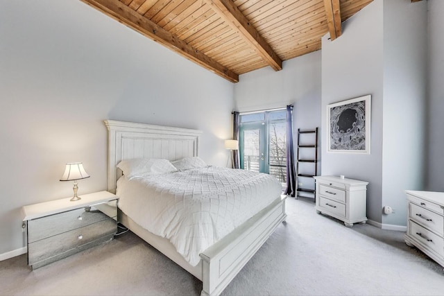 bedroom with wooden ceiling, light carpet, beam ceiling, baseboards, and access to exterior