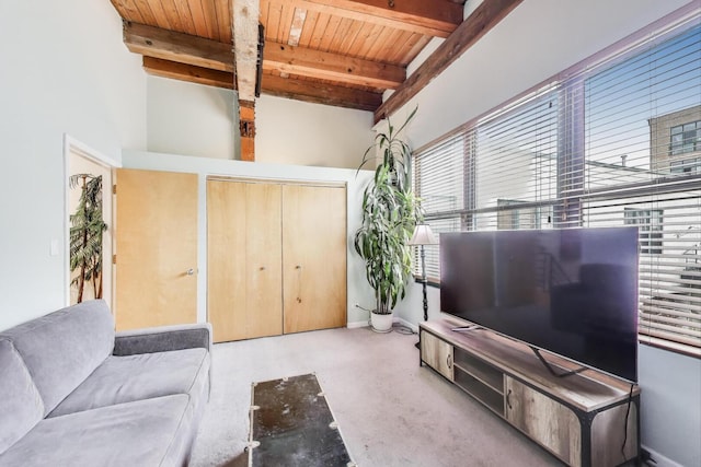 living room featuring wood ceiling, beam ceiling, baseboards, and a high ceiling