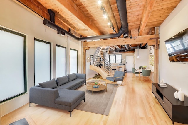 living room with wooden ceiling, wood finished floors, beamed ceiling, stairway, and rail lighting