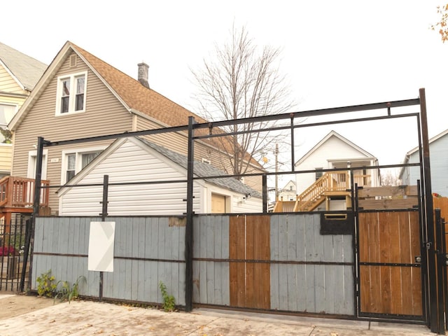 view of gate with a fenced front yard