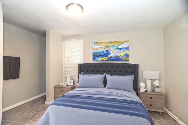 tiled bedroom featuring baseboards