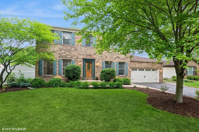 1057 Ponca Dr, Batavia, IL 60510 - colonial house featuring driveway, a front lawn, an attached garage, and brick siding