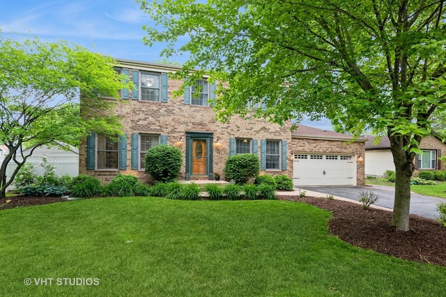 1057 Ponca Dr, Batavia, IL 60510 - colonial inspired home featuring concrete driveway, a front yard, and a garage