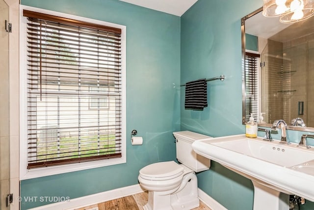 1057 Ponca Dr, Batavia, IL 60510 - bathroom featuring toilet, baseboards, a sink, and plenty of natural light