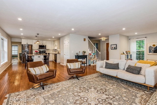 1057 Ponca Dr, Batavia, IL 60510 - living area featuring dark wood finished floors, stairs, and recessed lighting
