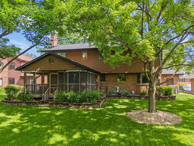 22W281 Mccarron Rd, Glen Ellyn, IL 60137 - rear view of house with a sunroom, a lawn, a chimney, and brick siding