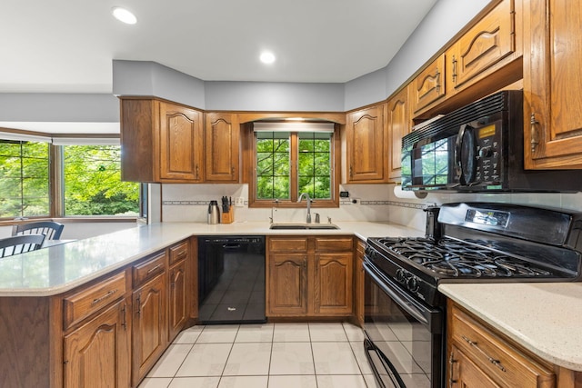 22W281 Mccarron Rd, Glen Ellyn, IL 60137 - kitchen featuring black appliances, a peninsula, light tile patterned floors, brown cabinetry, and recessed lighting