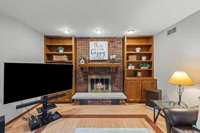 22W281 Mccarron Rd, Glen Ellyn, IL 60137 - living area with a fireplace, light wood-style flooring, and built in features