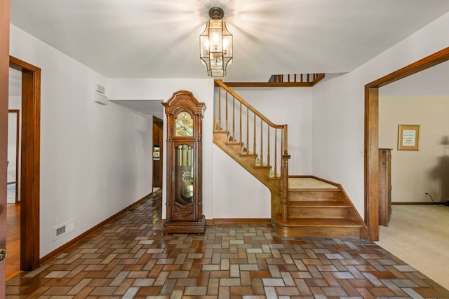22W281 Mccarron Rd, Glen Ellyn, IL 60137 - entryway featuring stairway, brick flooring, and a chandelier