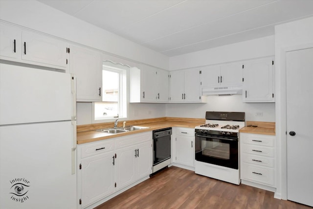 kitchen featuring freestanding refrigerator, black dishwasher, gas range, under cabinet range hood, and a sink