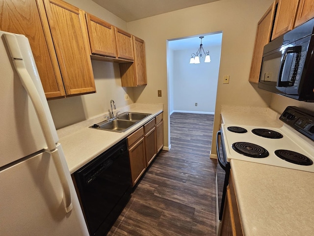 kitchen featuring dark wood-style flooring, a sink, light countertops, a chandelier, and black appliances