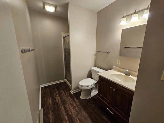 full bath featuring toilet, a shower stall, wood finished floors, and vanity