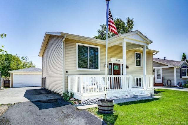16165 Haven Ave, Orland Hills, IL 60487 - view of front of property featuring covered porch, a detached garage, an outbuilding, and a front yard