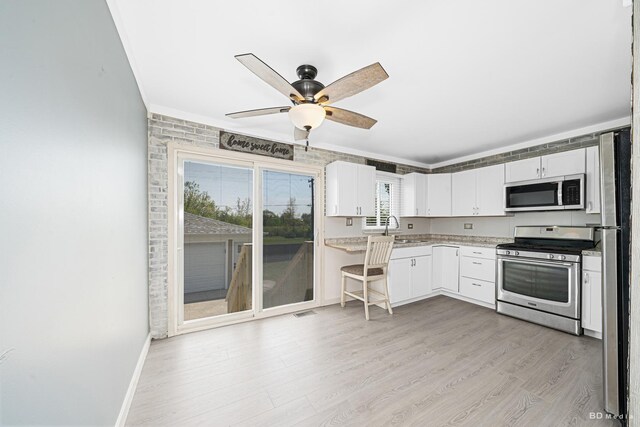 16165 Haven Ave, Orland Hills, IL 60487 - kitchen with appliances with stainless steel finishes, light wood-style flooring, white cabinetry, a ceiling fan, and baseboards