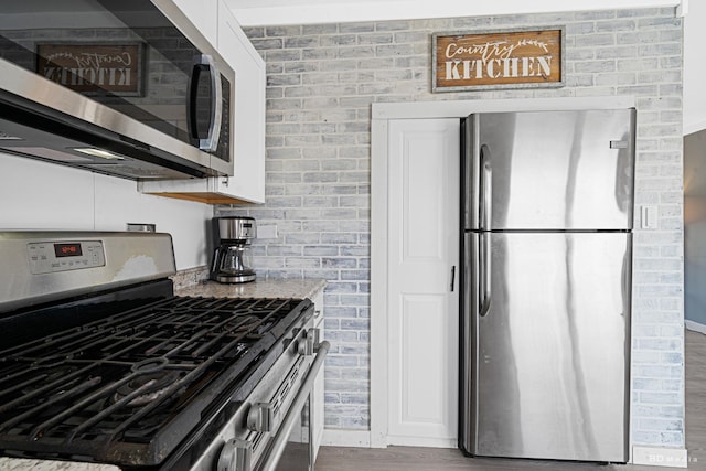 16165 Haven Ave, Orland Hills, IL 60487 - kitchen with stainless steel appliances, wood finished floors, light stone counters, and white cabinets