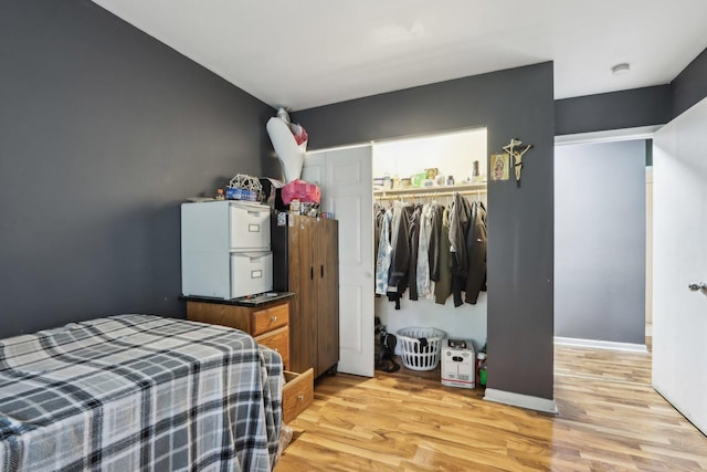 600 Mesa Dr Unit 103, Hoffman Estates, IL 60169 - bedroom featuring a closet, light wood finished floors, and freestanding refrigerator