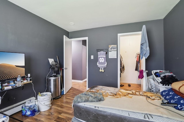 600 Mesa Dr Unit 103, Hoffman Estates, IL 60169 - bedroom featuring wood finished floors and a baseboard radiator