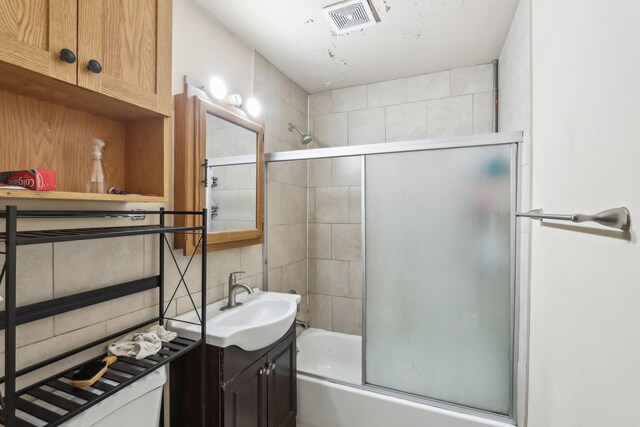 600 Mesa Dr Unit 103, Hoffman Estates, IL 60169 - full bath featuring decorative backsplash, combined bath / shower with glass door, and vanity