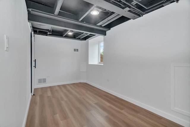 413 Wheeler Ave, Joliet, IL 60436 - below grade area featuring baseboards, wood finished floors, and visible vents