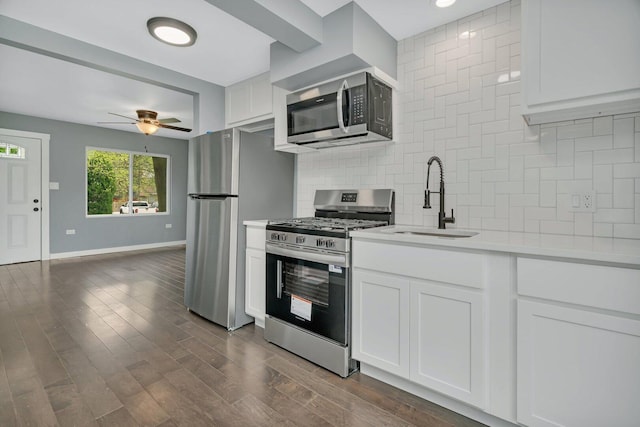 413 Wheeler Ave, Joliet, IL 60436 - kitchen with decorative backsplash, a ceiling fan, a sink, light countertops, and stainless steel appliances