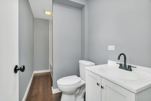 413 Wheeler Ave, Joliet, IL 60436 - bathroom featuring vanity, toilet, baseboards, wood finished floors, and a shower