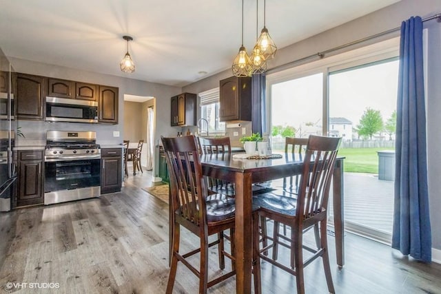 4524 Deames St, Plano, IL 60545 - dining space featuring light wood-style floors, baseboards, and a chandelier