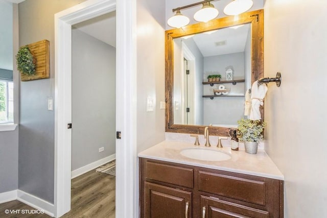 4524 Deames St, Plano, IL 60545 - bathroom with baseboards, wood finished floors, and vanity
