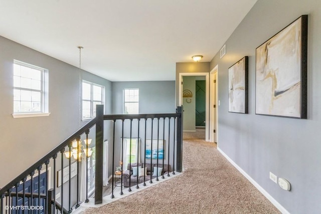 4524 Deames St, Plano, IL 60545 - corridor with carpet floors, baseboards, visible vents, and an upstairs landing