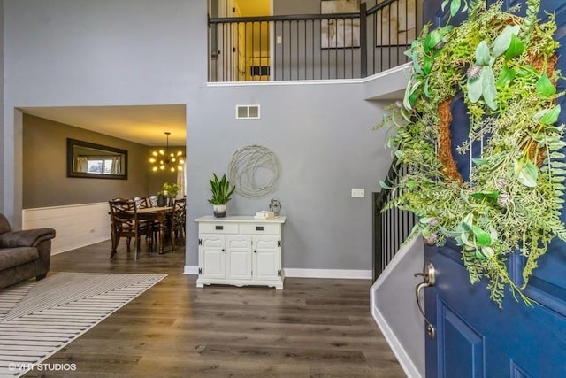 4524 Deames St, Plano, IL 60545 - entrance foyer featuring a towering ceiling, a notable chandelier, dark wood-style flooring, and visible vents