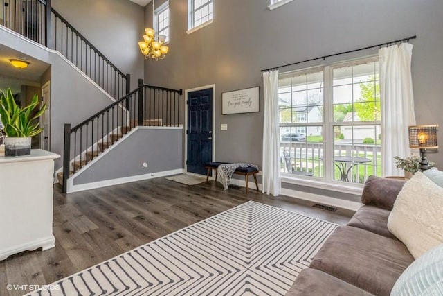 4524 Deames St, Plano, IL 60545 - living area featuring visible vents, a towering ceiling, wood finished floors, baseboards, and stairway