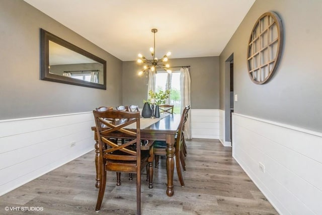 4524 Deames St, Plano, IL 60545 - dining room featuring a wainscoted wall, wood finished floors, and a chandelier