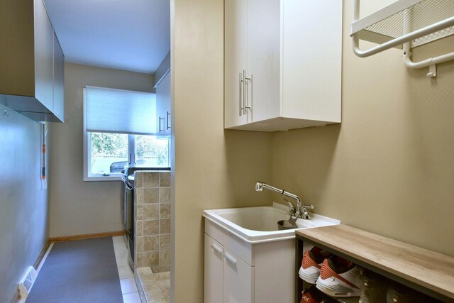bathroom featuring tile patterned flooring, baseboards, and vanity