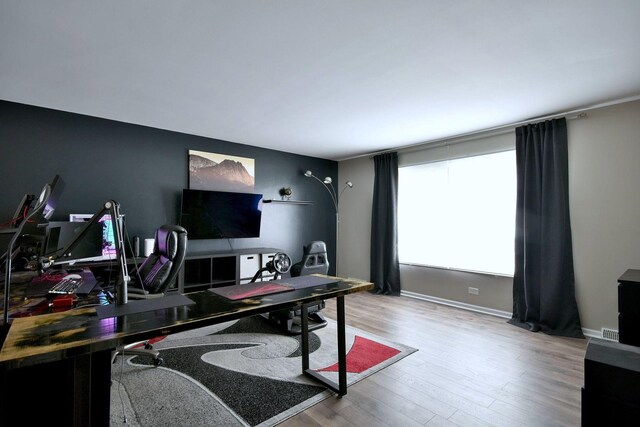 office with baseboards and wood finished floors