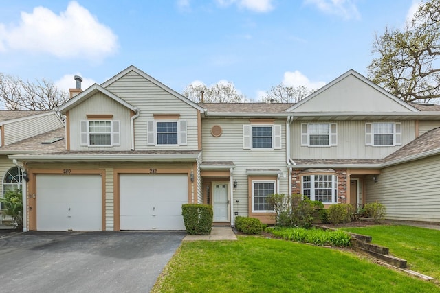 282 Ascot Ln, Streamwood, IL 60107 - view of property with asphalt driveway, a front yard, a garage, a chimney, and a shingled roof