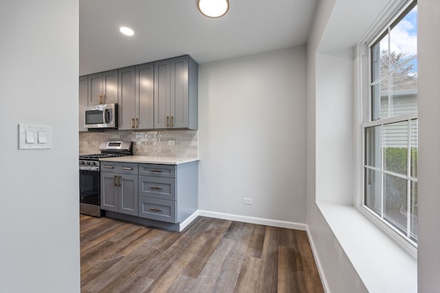 282 Ascot Ln, Streamwood, IL 60107 - kitchen with stainless steel appliances, gray cabinets, healthy amount of natural light, dark wood-style flooring, and recessed lighting