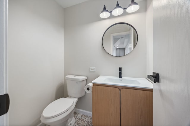 282 Ascot Ln, Streamwood, IL 60107 - bathroom with baseboards, toilet, vanity, and tile patterned floors
