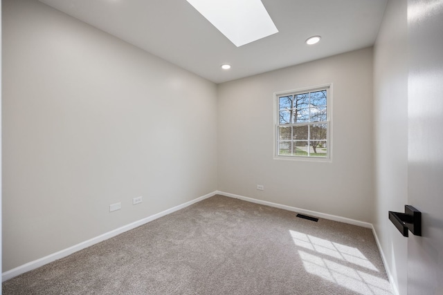 282 Ascot Ln, Streamwood, IL 60107 - spare room with a skylight, carpet floors, recessed lighting, and baseboards