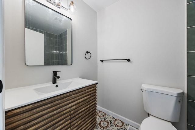 282 Ascot Ln, Streamwood, IL 60107 - bathroom featuring toilet, baseboards, and vanity