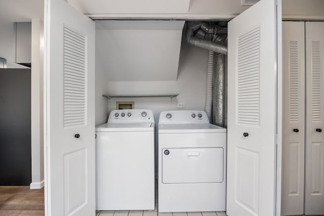 282 Ascot Ln, Streamwood, IL 60107 - clothes washing area with washing machine and dryer and light wood finished floors