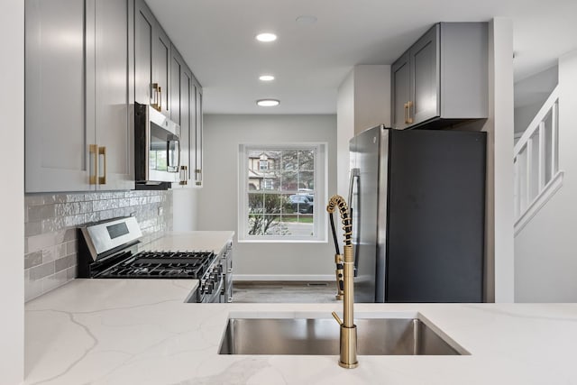 282 Ascot Ln, Streamwood, IL 60107 - kitchen featuring stainless steel appliances, light stone countertops, recessed lighting, a sink, and decorative backsplash