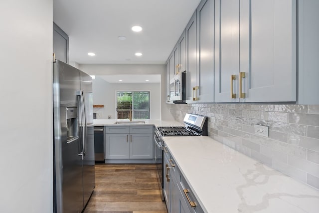 282 Ascot Ln, Streamwood, IL 60107 - kitchen featuring appliances with stainless steel finishes, gray cabinetry, recessed lighting, dark wood-style floors, and light stone counters