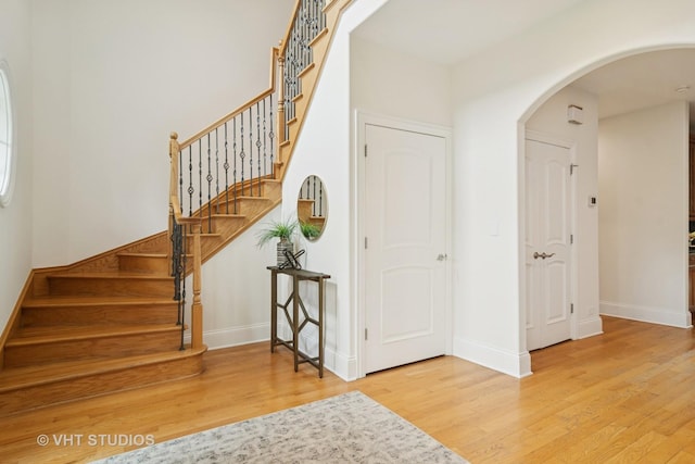 1238 N Illinois Ave, Arlington Heights, IL 60004 - entryway with wood finished floors, arched walkways, and stairs