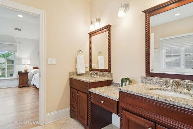 1238 N Illinois Ave, Arlington Heights, IL 60004 - bathroom with two vanities, ensuite bath, and wood finished floors