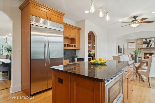 1238 N Illinois Ave, Arlington Heights, IL 60004 - kitchen featuring built in appliances, arched walkways, light wood finished floors, and recessed lighting
