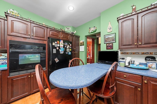 606 N Brainard Ave, La Grange Park, IL 60526 - kitchen with black appliances, light tile patterned flooring, dark countertops, dark brown cabinets, and a breakfast bar area