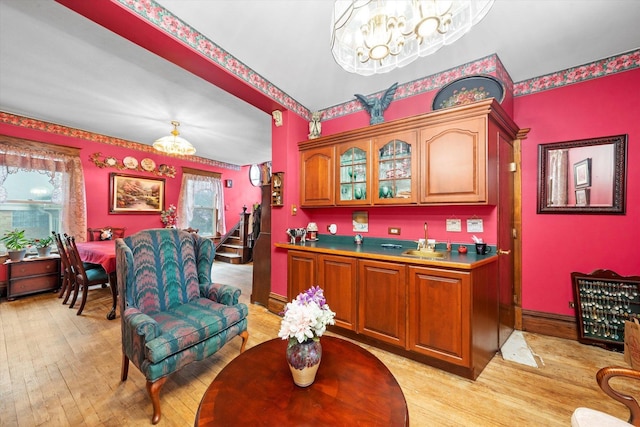 606 N Brainard Ave, La Grange Park, IL 60526 - bar area with a chandelier, light wood-type flooring, stairs, a sink, and baseboards